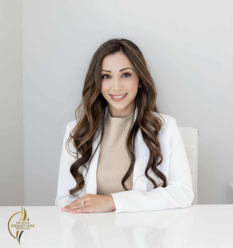 Professional headshot of Rana Papale, PharmD, clinical pharmacist at Michigan Weight Loss Institute wearing a white coat and smiling against a light neutral background.